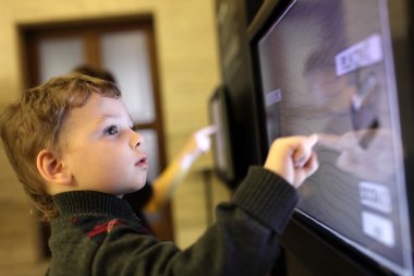 Child using touch screen clipart