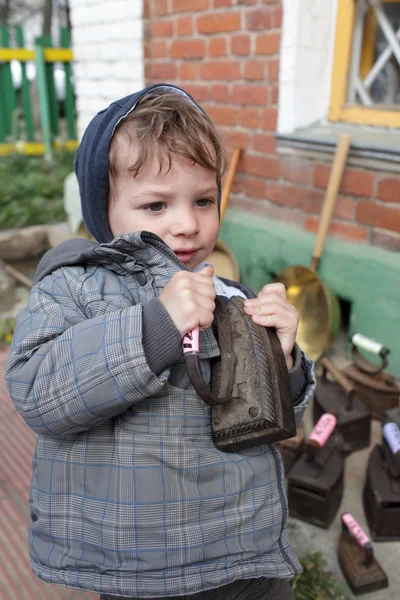 Child with vintage flat iron — Stock Photo, Image