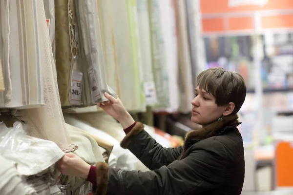 Girl choosing fabrics — Stock Photo, Image