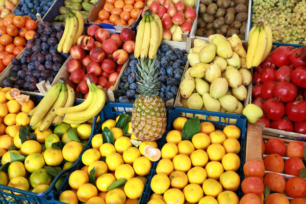 View of various fruits in boxes on market counter