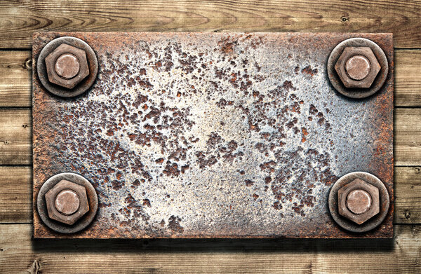 Old metal plate on wooden wall