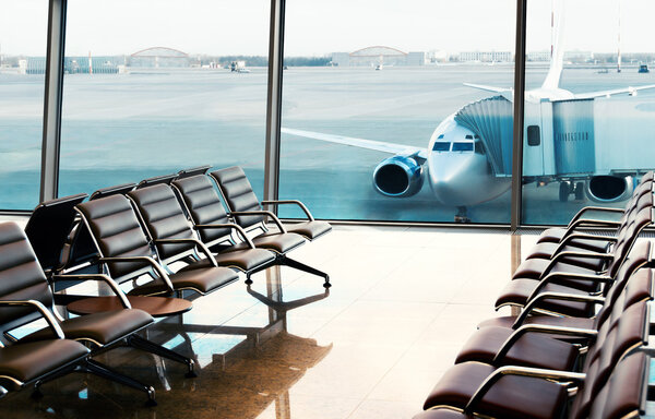 Seats, view from airport hall. Boarding.