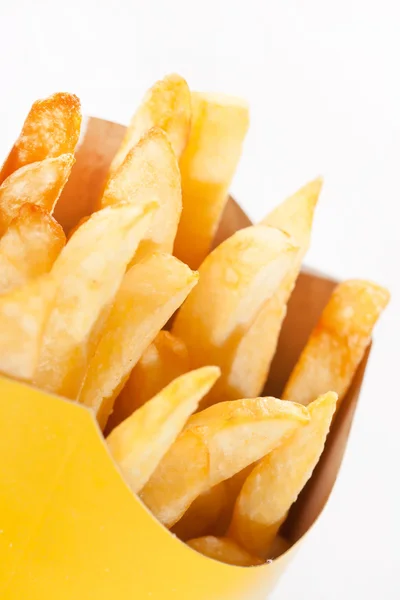 Pommes frites på en vit bakgrund — Stockfoto