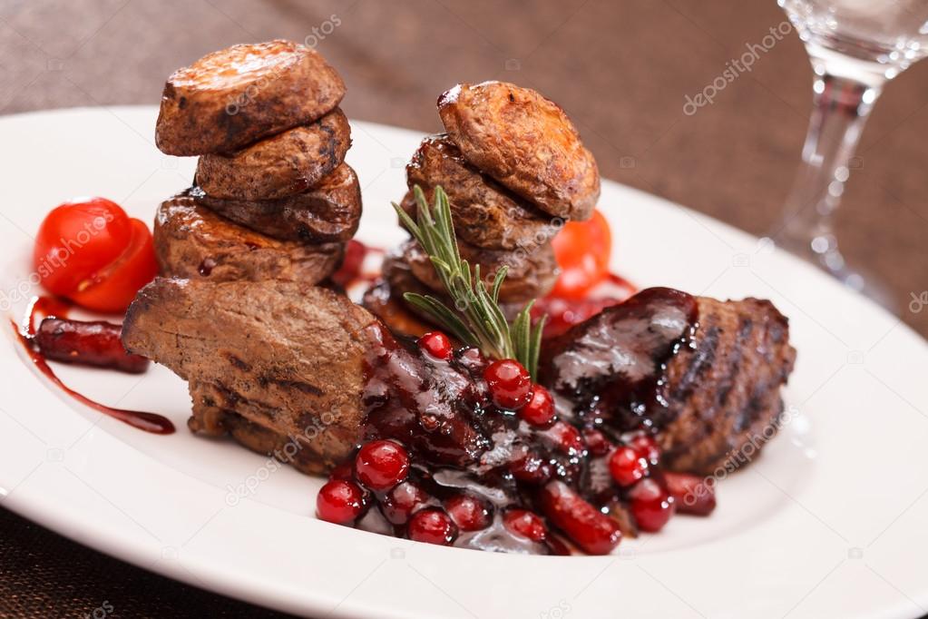 Beef steak with potatoes and cranberry sauce
