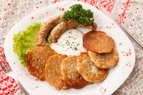 Potato pancakes with sausage — Stock Photo, Image