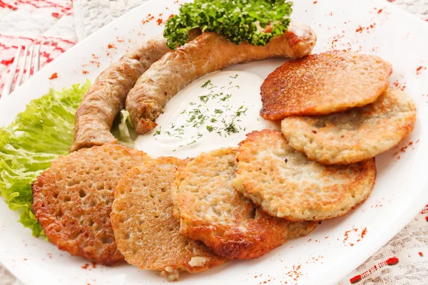 Potato pancakes with sausage — Stock Photo, Image