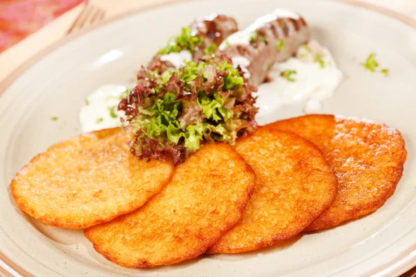 Potato pancakes with sausages — Stock Photo, Image