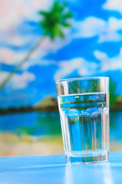 Glass of the water on the beach — Stock Photo, Image