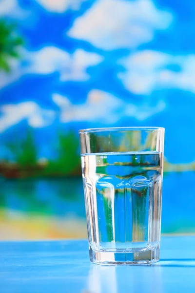 Glass of the water on the beach — Stock Photo, Image