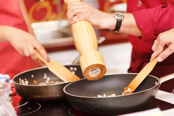 Chef seasoning meal with fresh sea salt — Stock Photo, Image