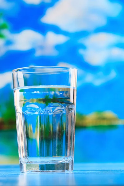 Glass of the water on the beach — Stock Photo, Image