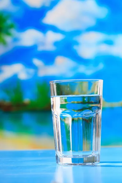 Glass of the water on the beach — Stock Photo, Image