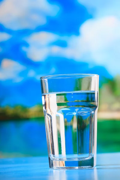 Glass of the water on the beach — Stock Photo, Image