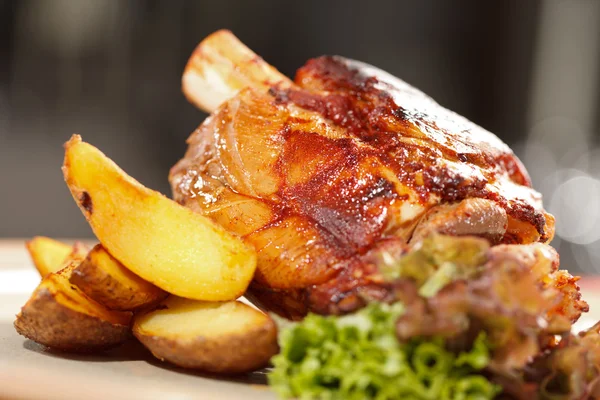 Roasted pork knuckle with potatoes — Stock Photo, Image