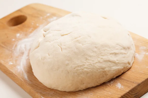 Dough on wooden board — Stock Photo, Image