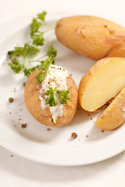 Baked potato filled with soft cheese — Stock Photo, Image