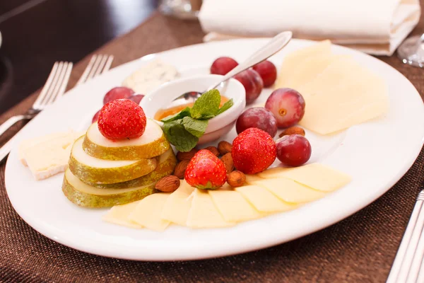 Cheeses and fruits for appetizers — Stock Photo, Image