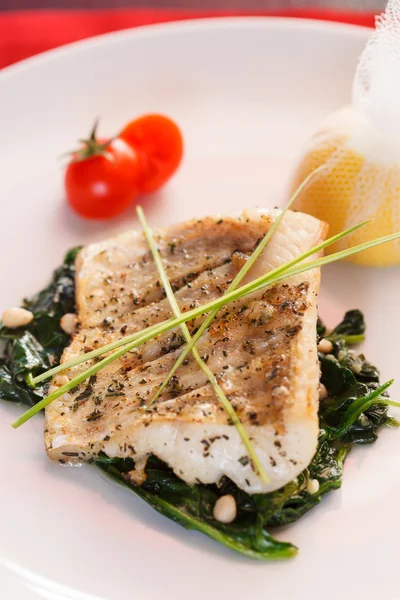 White fish with spinach Royalty Free Stock Images