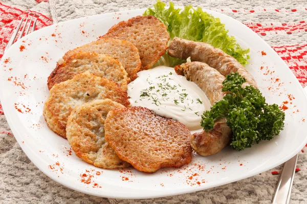 Potato pancakes with sausage — Stock Photo, Image