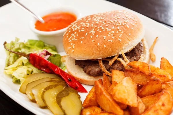 Burger with mug of beer — Stock Photo, Image