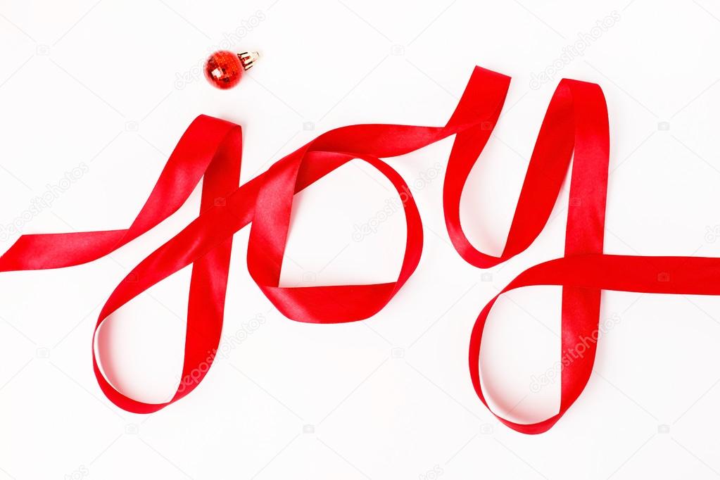 Joy word written in red ribbon