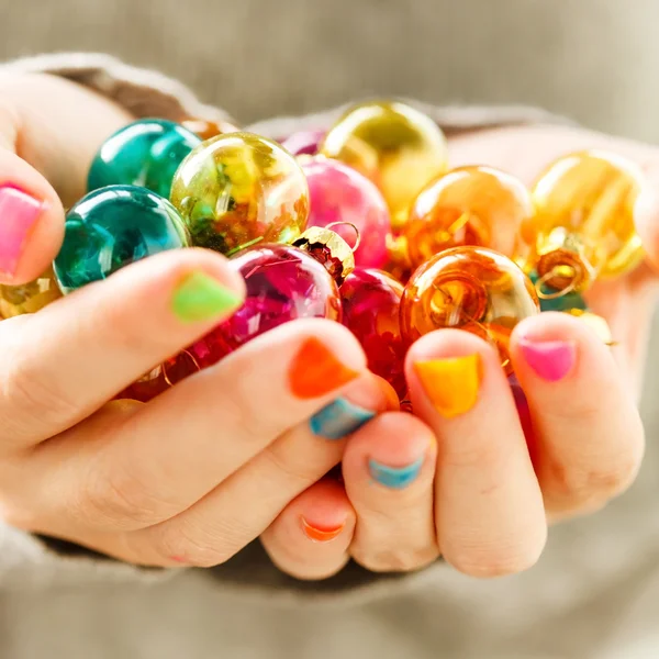 Christmas balls in the hands — Stock Photo, Image