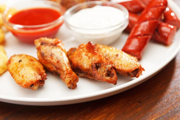 Appetizer plate with dipping sauces — Stock Photo, Image