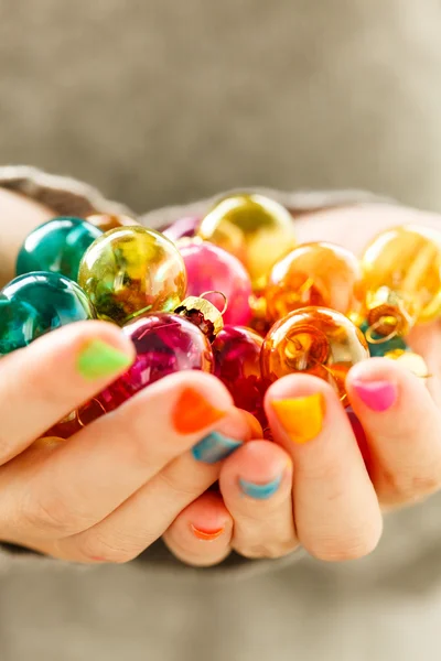Christmas balls in the hands — Stock Photo, Image