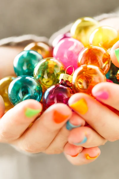Christmas balls in the hands — Stock Photo, Image