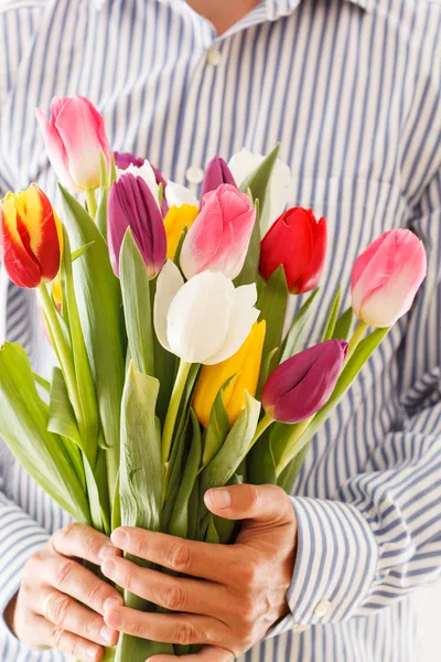 Bouquet of tulips in a hand — Stock Photo, Image