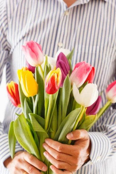 Bouquet of tulips in a hand — Stock Photo, Image