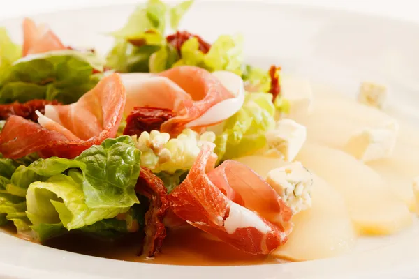 Appetizer with pear, cheese and ham — Stock Photo, Image