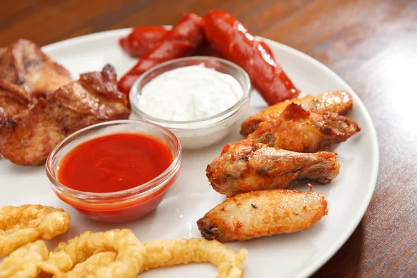 Appetizer plate with dipping sauces — Stock Photo, Image