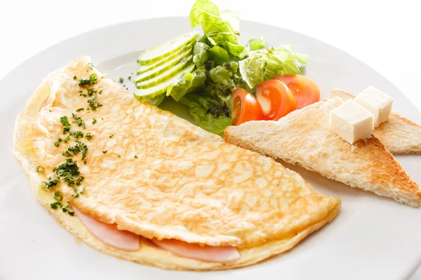 Omelette, vegetables and toasts with butter — Stock Photo, Image