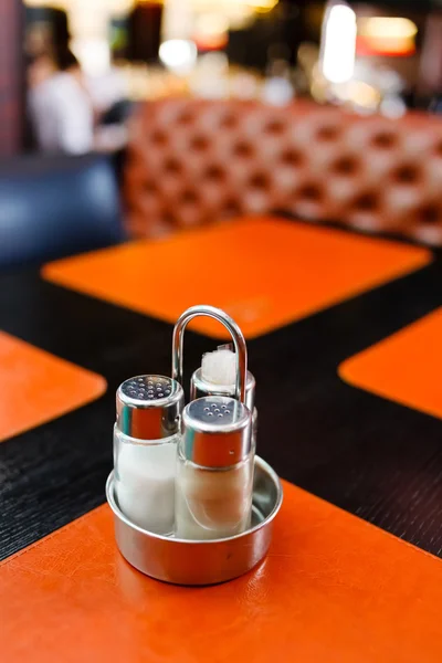 Pepper and salt shaker on table — Stok fotoğraf