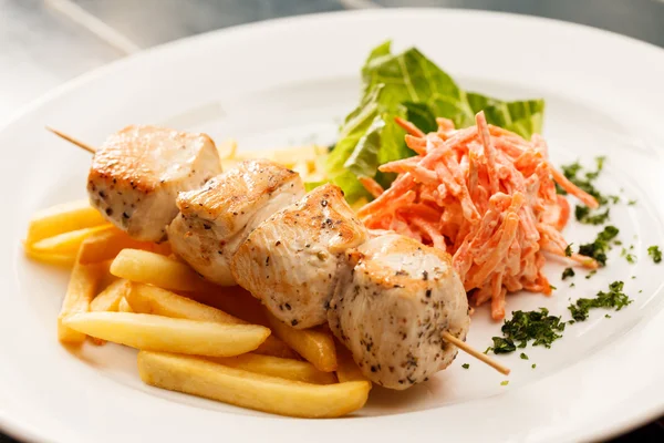 Chicken kebab with french fries — Stock Photo, Image