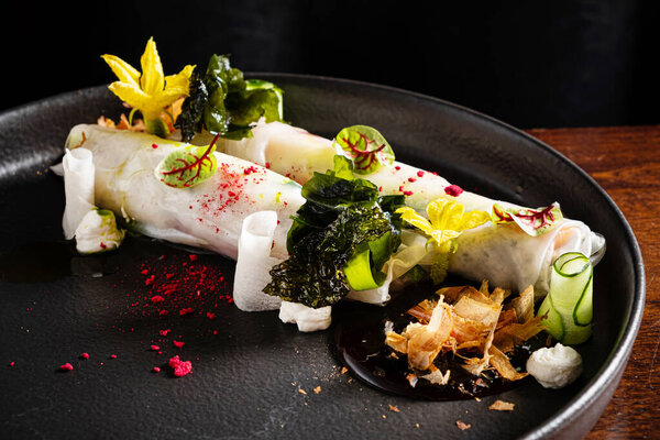 Vegetarian japanese spring rolls on dark plate