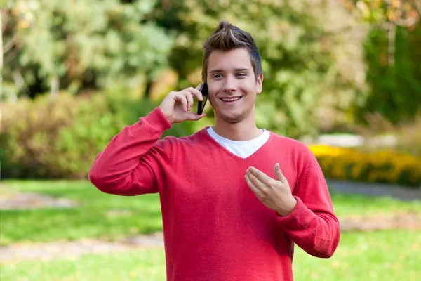 Young man communicating on smartphone — Stock Photo, Image