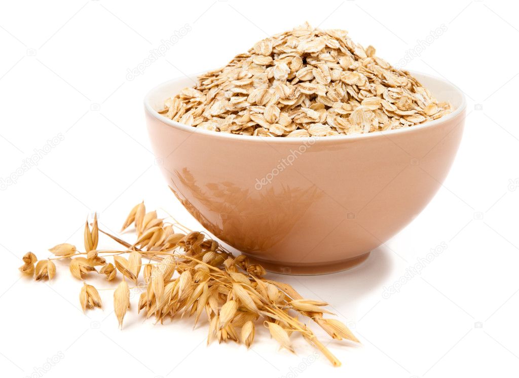 Rolled oats in a bowl isolated on white