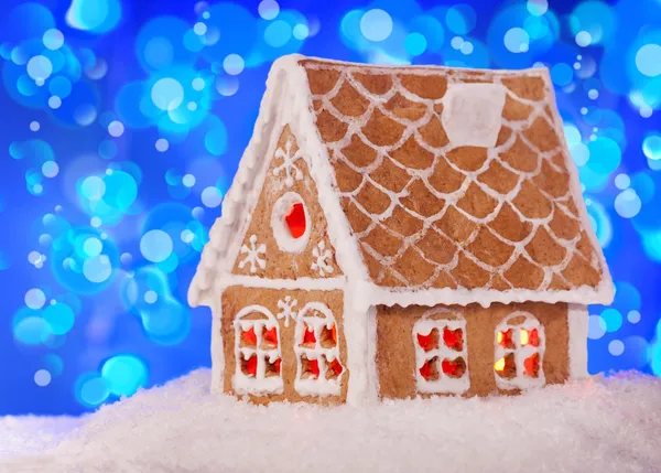 Gingerbread house in the snow with a beautiful New Year's backgr — Stock Photo, Image