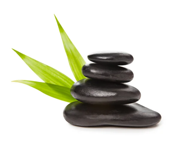 Zen concept - pyramid of black stones and bamboo leaves — Stock Photo, Image