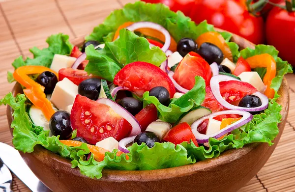 Delicious and healthy salad in a wooden bowl — Stock Photo, Image