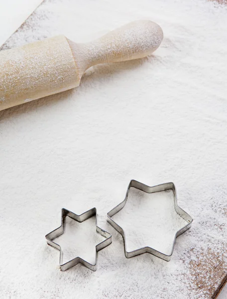 Rolling pin, flour and forms for cookies on the boards — Stock Photo, Image