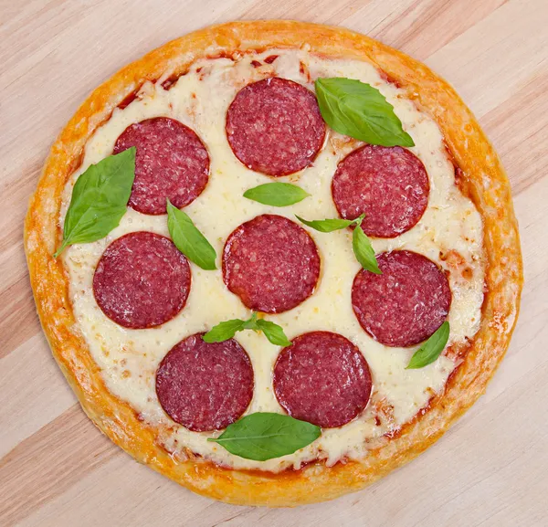 Fresh flavorful pepperoni pizza on wood — Stock Photo, Image