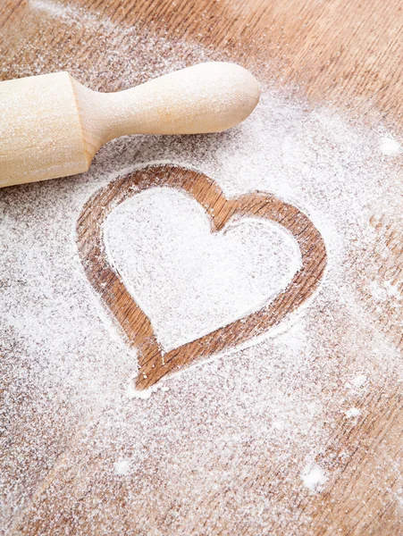 Heart of flour on wooden desk — Stock Photo, Image