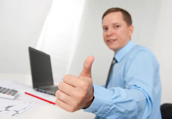Happy smiling young business man with thumbs up gesture Stock Photo