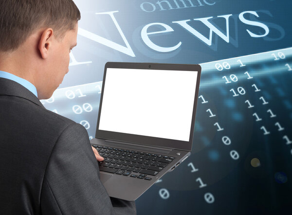 Businessman reading news at laptop computer