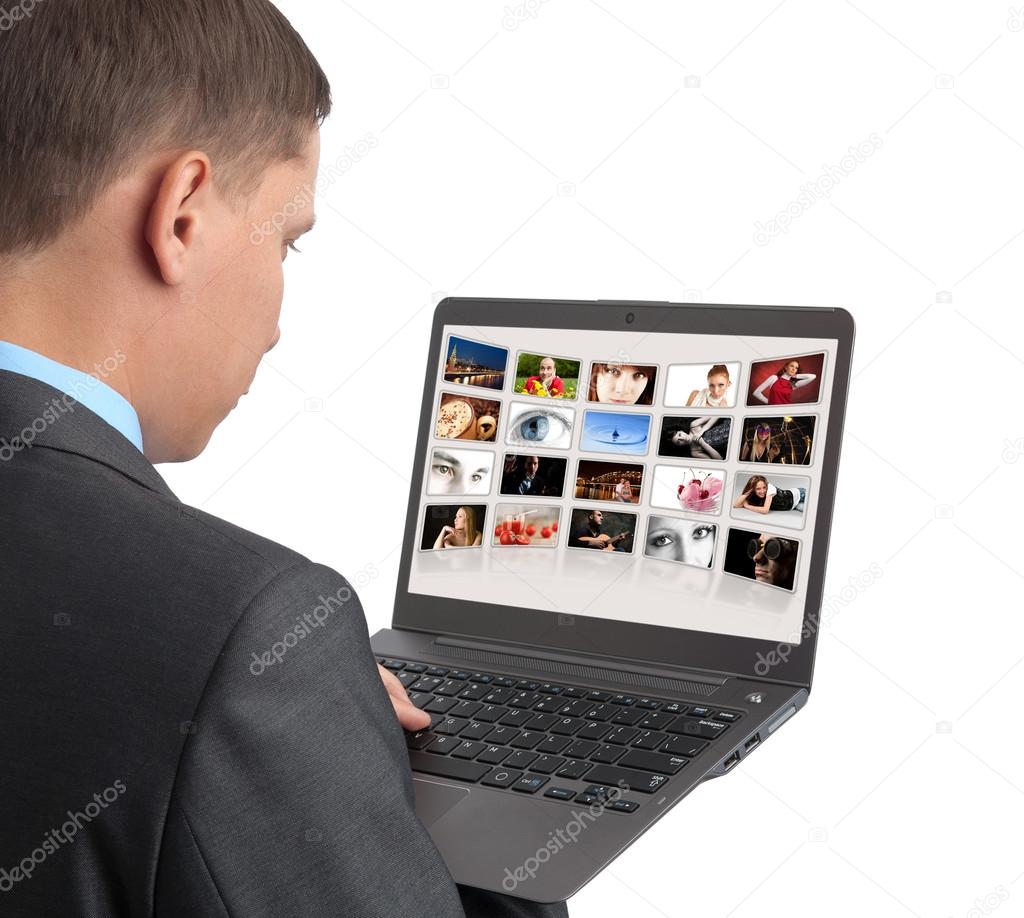 man looking some pictures on the laptop