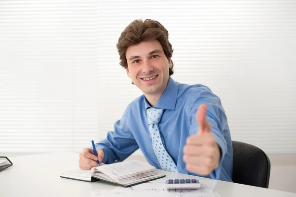 Businessman showing thumbs up gesture Stock Photo