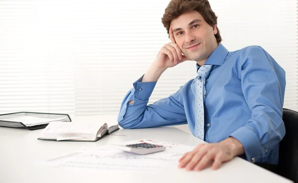 Portrait of a businessman sitting in his office Stock Image